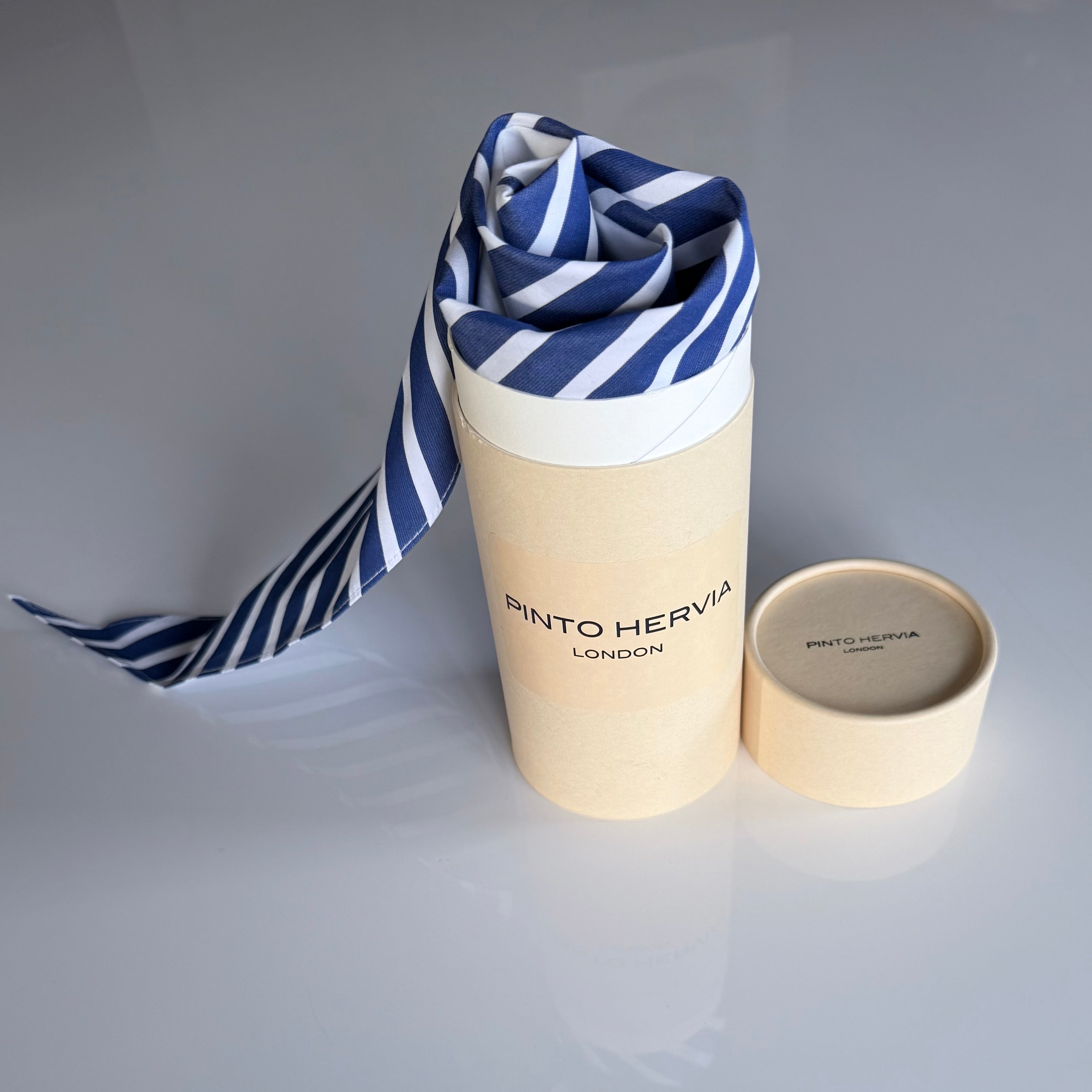 Blue striped Arrombo Scarf with branded Pinto Hervia London gift tube packaging