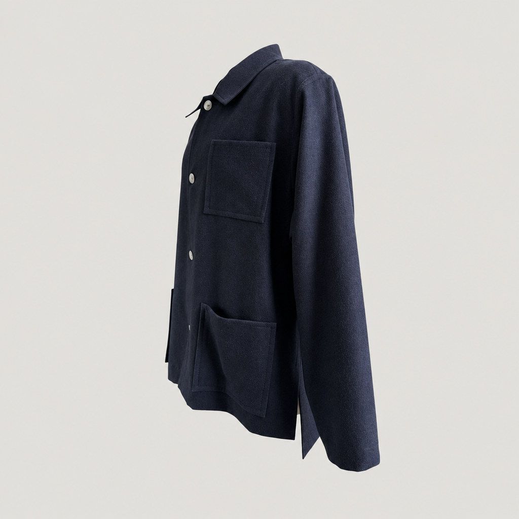 Side view of the PINTO HERVIA Frame Jacket in black wool showing relaxed structure and Aries underarm construction.
