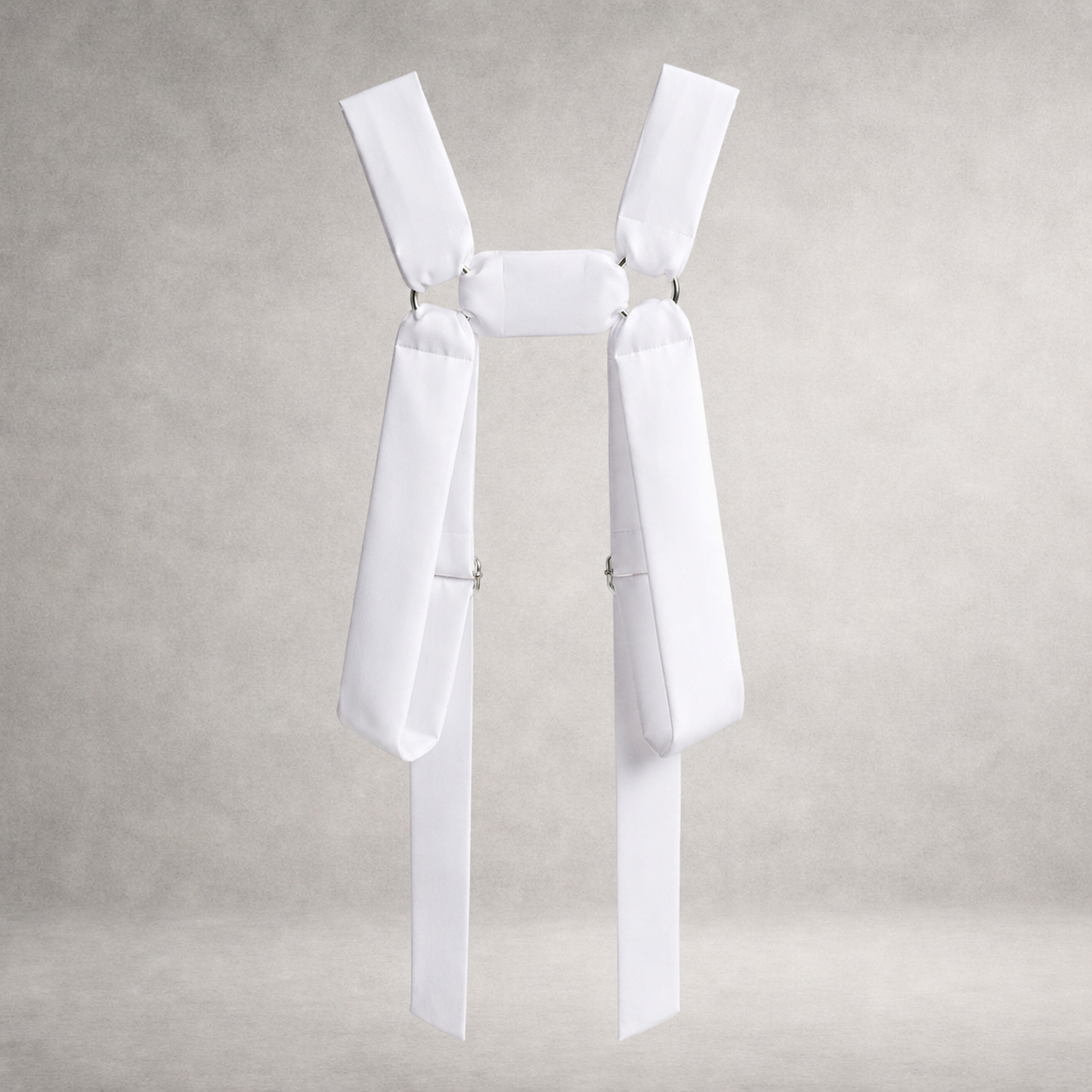 White PINTO HERVIA H-Frame harness with soft structured cotton panels and metal ring hardware.