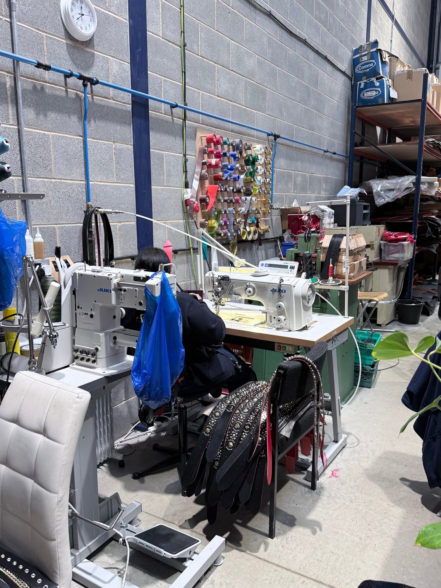A British workshop interior showing sewing machines and production tools.