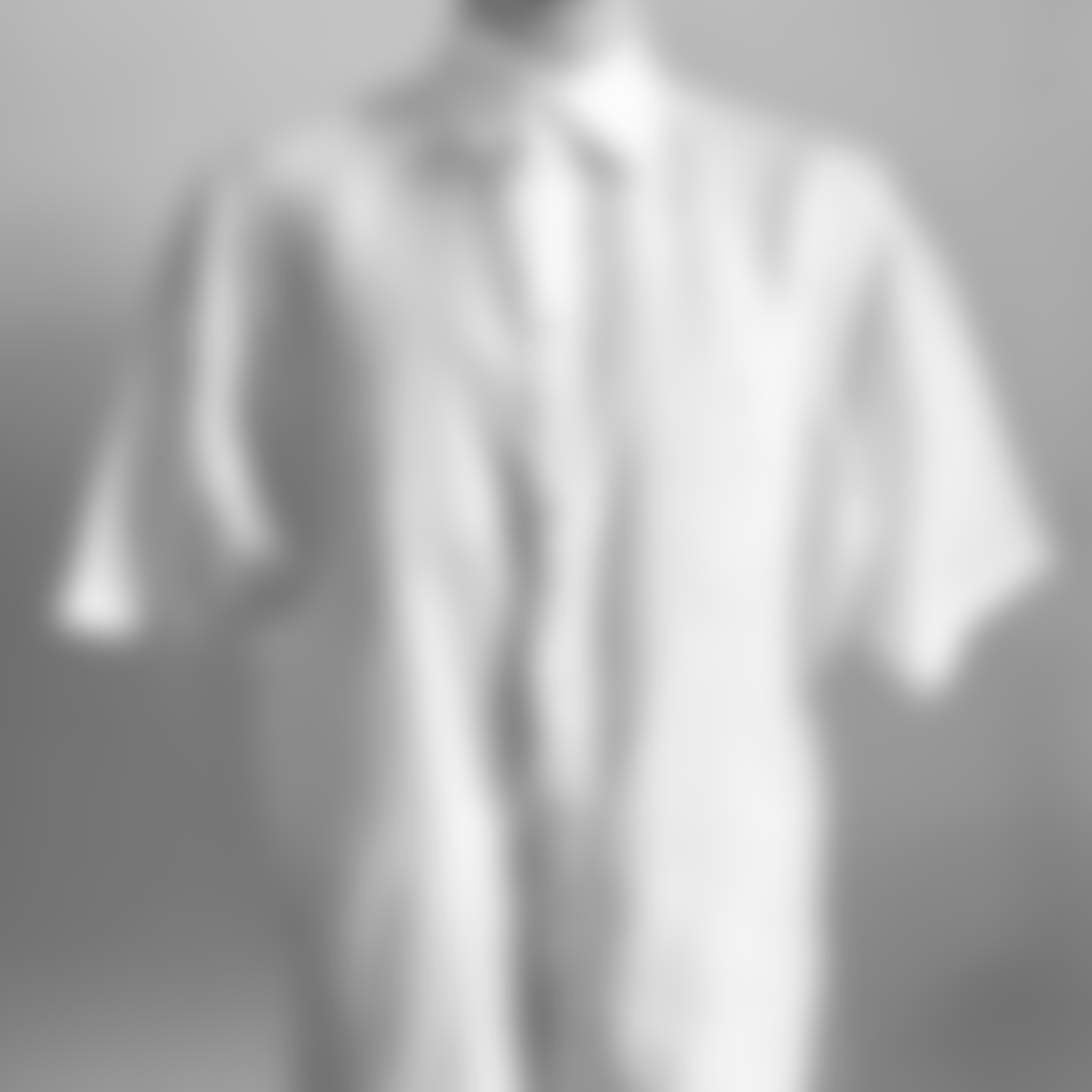 Blurred image of a white short-sleeve linen shirt on a mannequin, photographed against a neutral background.