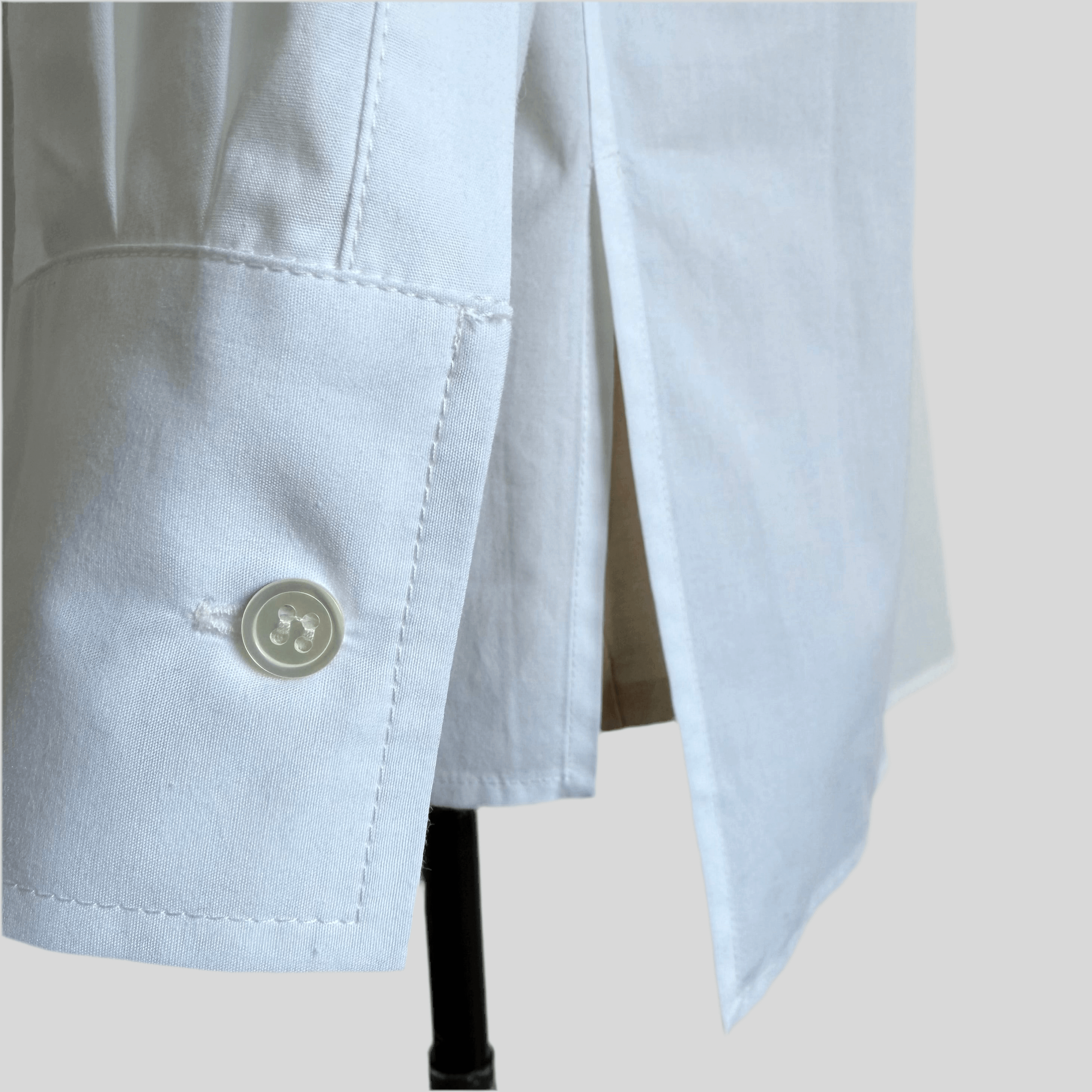 Mother-of-pearl cuff button detail on Aries shirt
