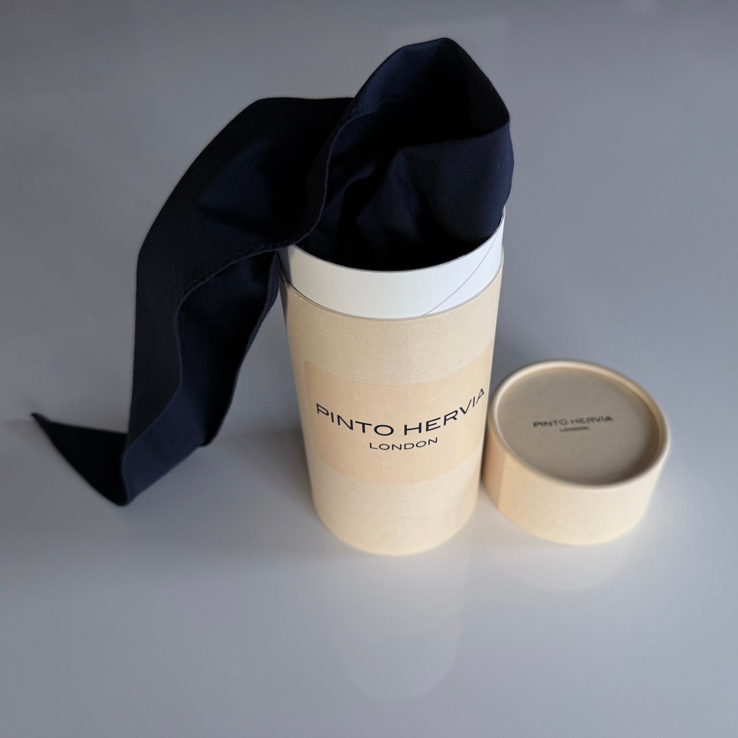 Black poplin Arrombo Scarf displayed with Pinto Hervia London branded packaging