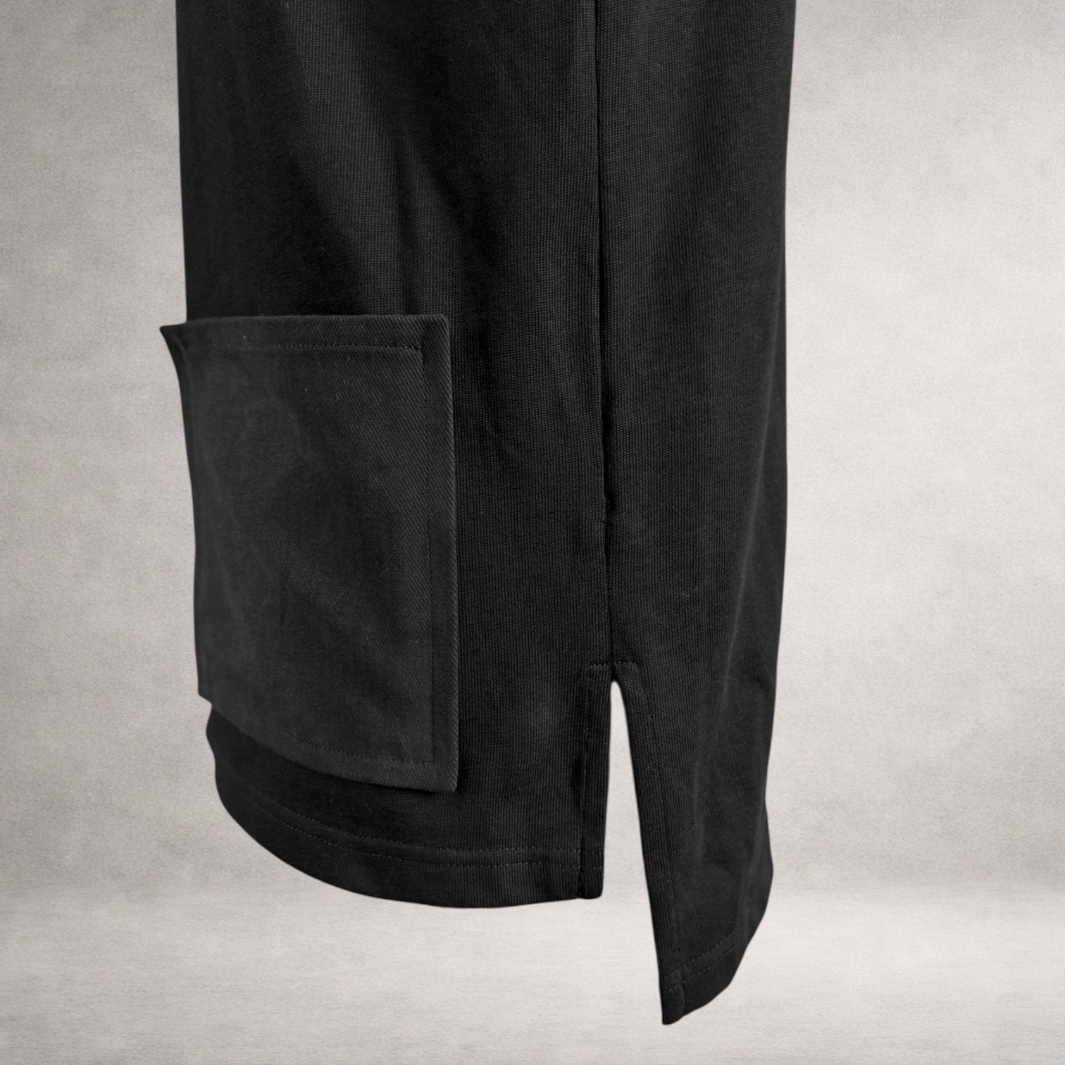 Black Atlas long sleeve jersey top with front patch pockets and extended back hem made in England side detail view.
