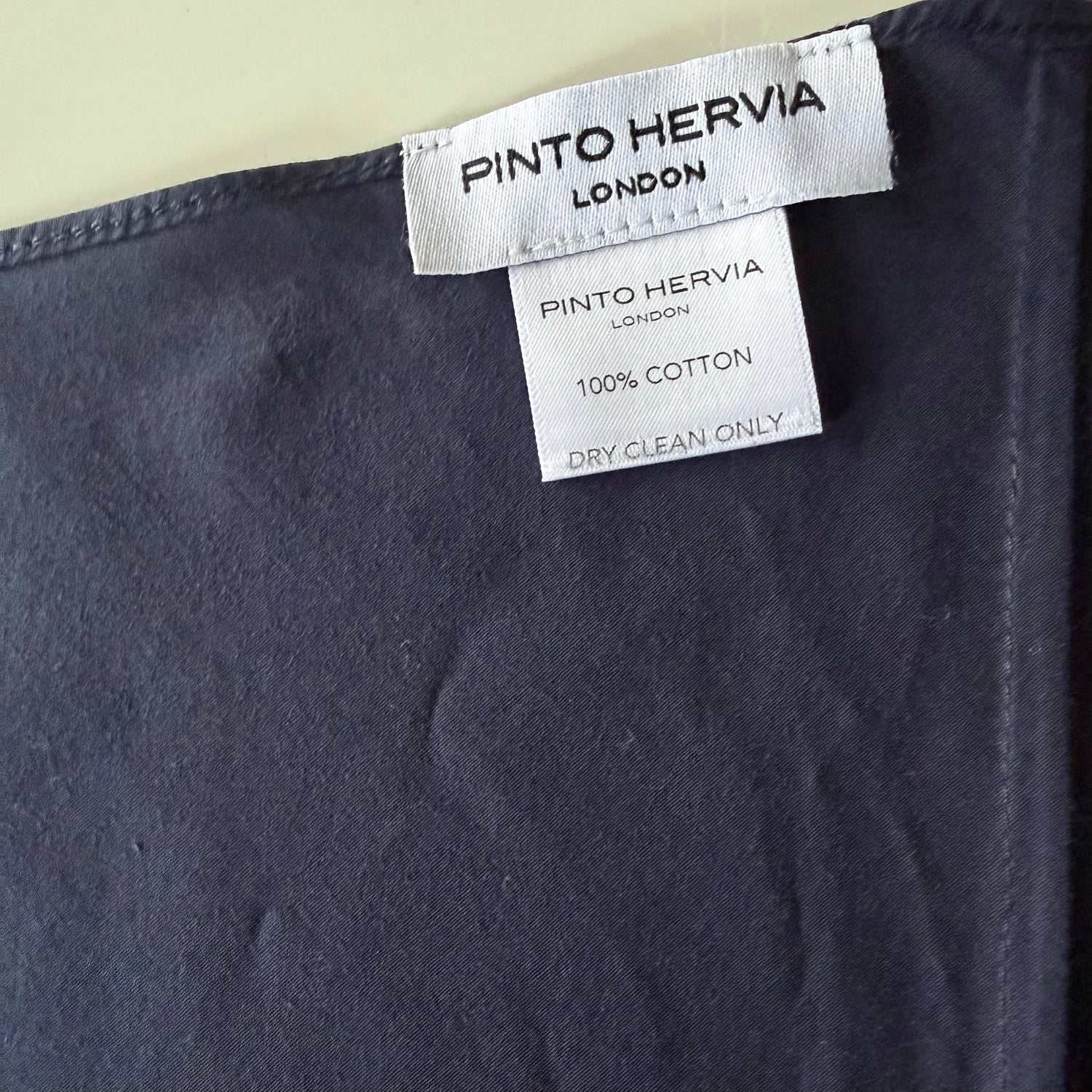 Close-up of mid-seam construction and poplin texture on navy Arrombo Scarf