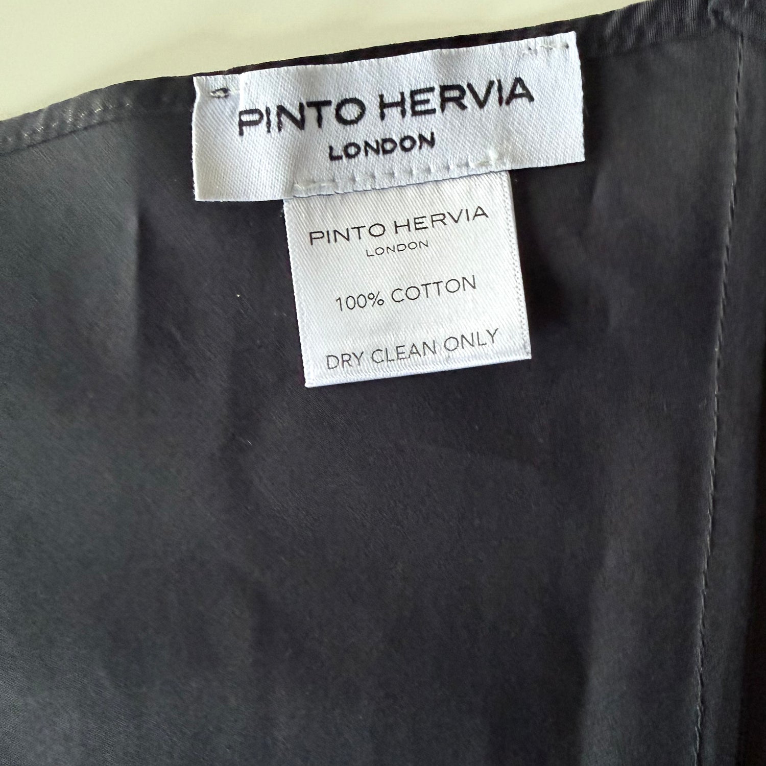 Close-up of structured seam detail and matte poplin finish on black Arrombo Scarf