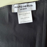 Close-up of structured seam detail and matte poplin finish on black Arrombo Scarf