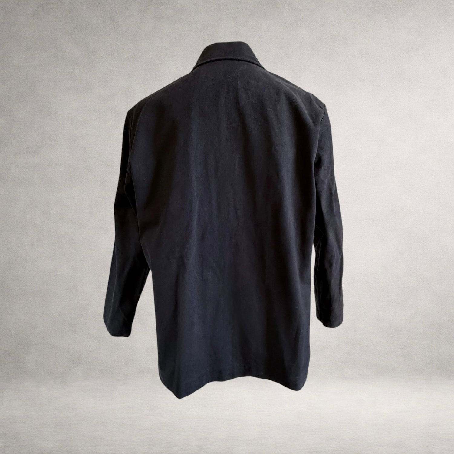 Back view of the PINTO HERVIA Frame Jacket in black cotton drill with relaxed silhouette and clean rear