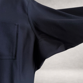 Detail view of the PINTO HERVIA Frame Jacket in black wool showing Aries underarm construction and fluid movement.
