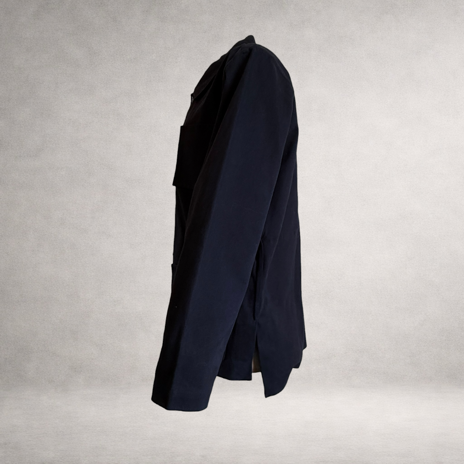 Side view of the PINTO HERVIA Frame Jacket in black cotton drill showing relaxed structure and Aries underarm construction.