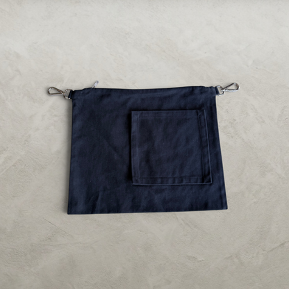 Front view of the PINTO HERVIA Frame Pouch in black cotton drill with oversized square external pocket.