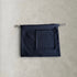 Detail view of the oversized square pocket on the black PINTO HERVIA Frame Pouch.