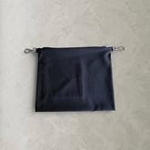 Rear detail view of the black PINTO HERVIA Frame Pouch showing soft construction and minimal finish.