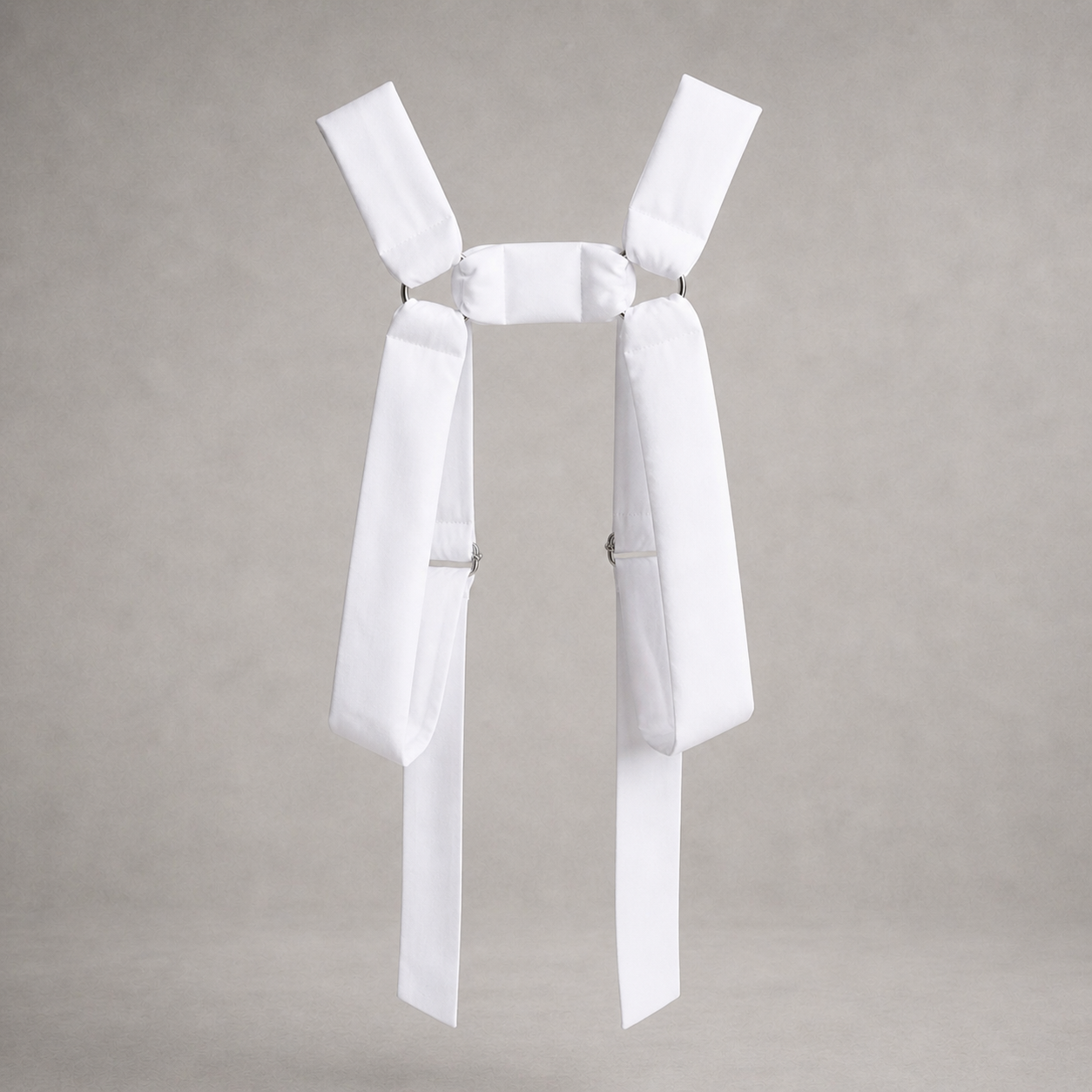 White PINTO HERVIA H-Frame harness with soft structured cotton panels and metal ring hardware.