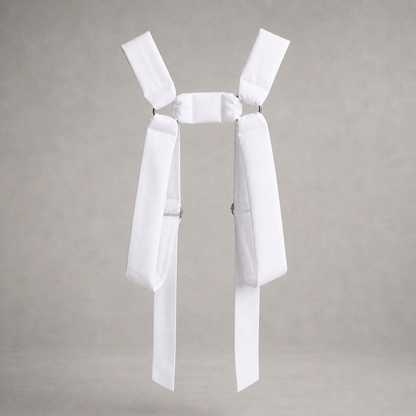 White PINTO HERVIA H-Frame harness with soft structured cotton panels and metal ring hardware.