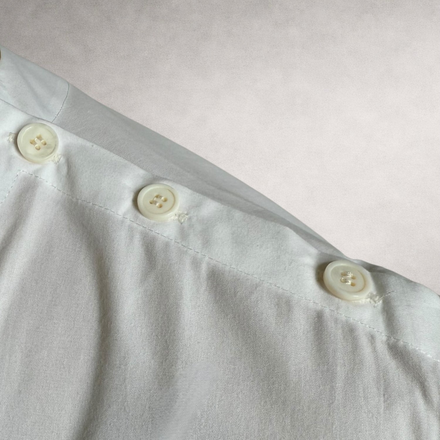White Aries 4 shirt detail showing shoulder button construction
