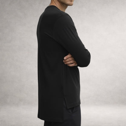 Black Atlas long sleeve top in jersey cotton, side view showing extended back length and split hem