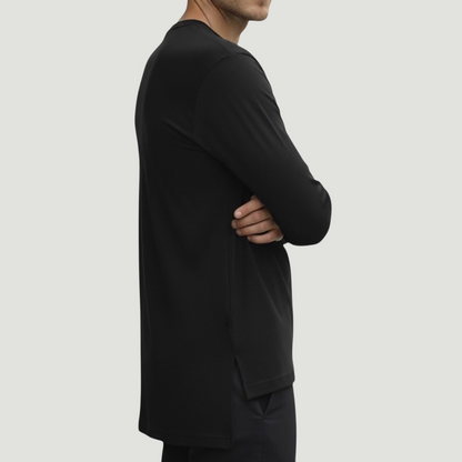 Black Atlas long sleeve top in jersey cotton, side view showing extended back length and split hem